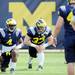 Michigan running back De'Veon Smith  and running back Wyatt Shallman warm up on the practice field outside of the Al Glick Field House on Thursday, August 8, 2013. Melanie Maxwell | AnnArbor.com 
